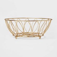 a gold metal bowl with curved lines in the center