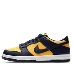 The Nike Dunk Low GS 'Michigan' is a special edition of the iconic 'Be True to Your School' series from 1985. This low-top version is offered in big kid sizing and pays homage to the Wolverines of Ann Arbor with an all-leather upper in Midnight Navy and Varsity Maize hues. The retro perforated toe box and lightly padded nylon tongue topped with a woven Nike tag are just some of the details that make this shoe so special. (SNKR/Skate/Low Top/Colorblock) Nike Collegiate Sneakers For Streetwear, Nike Casual Team-colored Sneakers, Sporty Nike Team-colored Sneakers, Nike Throwback Custom Sneakers For Sports, Nike Sneakers In Team Colors For Sports, Nike Casual Custom Sneakers For Sports Events, Collegiate Low-top Sneakers For Streetwear, Casual Nike Custom Sneakers, Casual Low-top Team-colored Basketball Shoes