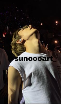 a man with his eyes closed in front of a crowd at a music concert, and the words sunocoart above him