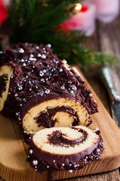 a chocolate roll on a wooden cutting board