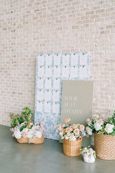 three baskets with flowers are sitting next to a sign that says your seat alwayss