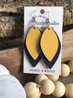 MICHIGAN fans....Cheer on your favorite COLLEGE Football Team with this pair of BLUE and MAIZE Leather Earrings GO WOLVERINES! Perfect for football spirit and so lightweight *Handmade with Genuine Leather *Leaf Shape *BLUE and MAIZE Leather-One pair *2.25inH *SILVER Nickel Free Earwire More Leather Earrings by Little Studio Design Co: https://etsy.me/2EV3ApC *Due to the naturalness of this product, the leather may vary in color slightly from item to item. I have done my best to accurately repres Yellow Leather Jewelry For Gifts, Leather Football Earrings, Football Spirit, Animal Print Earrings, Football Earrings, Leather Leaf, Fall Earrings, Maize, Studio Design