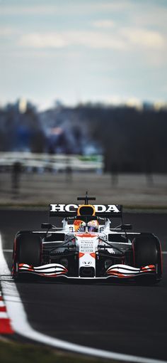 a red and white race car driving on a track