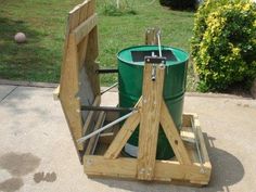 a green bucket sitting on top of a wooden stand