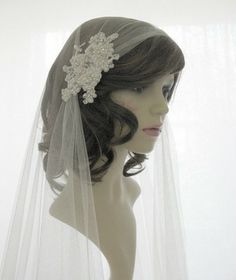 a mannequin wearing a bridal veil with flowers on the head and hair