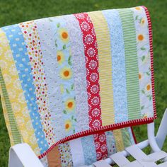 a colorful blanket sitting on top of a white lawn chair