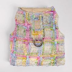 a multicolored purse with a ring on it