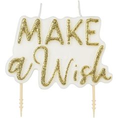 a cake topper that says make a wish with gold glitters on the letters