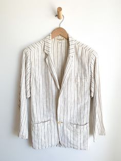 Subtle brown stripes on natural eggshell background linen blazer. Minimalist cut. Menswear look. Convenient pockets. Fabric: LinenLabel: Gianni VersaceFit: M/L Measurements: Bust 38" Shoulder 17" Sleeve 24" Length 30.5" Waist 34" Condition: Very good. Slight yellowing around collar, very small chip in button. Classic Striped Linen Blazer, Beige Linen Blazer With Patch Pockets, Striped Blazer With Pockets And Lapel Collar, Striped Linen Blazer For Spring, Spring Striped Linen Blazer, Beige Linen Blazer With Relaxed Fit, Spring Striped Blazer With Welt Pockets, Striped Blazer With Welt Pockets For Spring, Summer Striped Long Sleeve Blazer