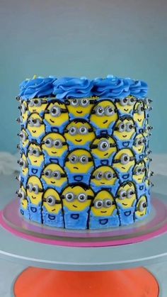 a blue and yellow cake decorated with minion faces