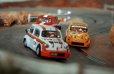 two toy cars driving on a race track