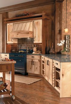 a kitchen with wooden cabinets and blue stove top oven next to a dining room table