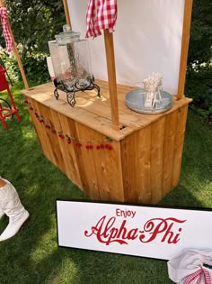 an ice chest with coca - cola on it and other items sitting in the grass