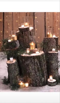 candles are placed on logs in the snow