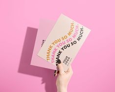 two thank you cards being held up against a pink background with the words thank you so much