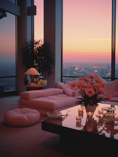 a living room filled with furniture and a large window overlooking the city at night time