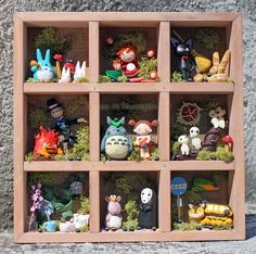 a wooden shelf filled with lots of toy animals