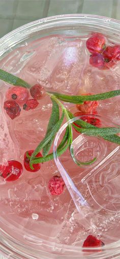 a close up of a drink with cherries on the rim