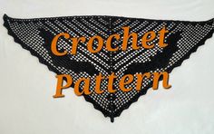 an orange and black crochet pattern on a white shirt