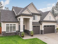 a large house with two garages in the front yard