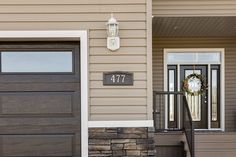 the front door of a house with a wreath on it