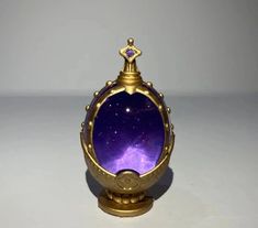 a purple glass ball with a gold frame around it