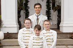 a group of young boys dressed in white and gold