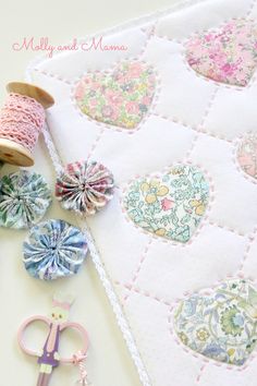 sewing supplies are laid out on a table with a piece of fabric next to them