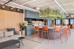 a living room filled with furniture next to a kitchen