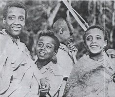 an old black and white photo of three men in front of a tree with scissors