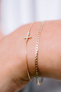 Our Esther Dainty Diamond Cross Bracelet is a glimmering beacon of faith. Stylish and elegant, this bracelet embodies the beauty of His grace. Perfect to shine on its own but sophisticated enough to add to a stack. The intentional delicacy of this design makes for the heartfelt gift of a child's first piece of fine jewelry or an adult's everyday dainty wear. Metal: 18k White Gold / 18k Yellow Gold / 18k Rose Gold Round Brilliant Cut Natural Diamonds: Approx. 0.10 ctw G Color and SI1-2 Clarity Diamonds Length: 7 inches at the longest. ﻿Adjustable sliding bead to provide options for smaller wrist size. Closure: Lobster clasp Measurements: Approx. 11.7mm length x 5.9mm width Looking for a different size? Please email us. Elegant Adjustable Cross Bracelet, Elegant Yellow Gold Rosary Bracelet With Cross, Elegant Yellow Gold Cross Rosary Bracelet, Elegant Cross Rosary Bracelet As Gift, Elegant Rosary Bracelet With Cross For Gift, Timeless Bracelets With Diamond Accents For Gift, Elegant Cross-shaped Rosary Bracelet For Wedding, Elegant Cross Rosary Bracelet For Wedding, Timeless Hand Set Bracelets As Gift