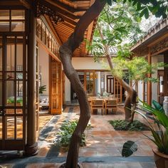 the inside of a house with an elephant statue in the center and plants on the outside