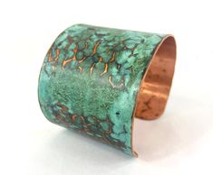 These unique, hand-formed copper and brass cuff bracelets with vibrant patinas create stunning accents to your personal style. Dress up or down- either way you'll be wearing an adornment that will turn heads, start conversations, and delight the eye of the beholder. This is a copper cuff with a beautiful blue-green marbled patina that has been lifted away in spots to reveal the hammer marks in the metal. Please note that patina colors will look different depending on the screen/device you view t Brass Cuff Bracelet With Patina As A Gift, Artistic Adjustable Patina Cuff Bracelet, Unique Hammered Brass Cuff Bracelet, Adjustable Patina Cuff Bracelet Wearable Art, Unique Patina Cuff Bangle Bracelet, Adjustable Patina Cuff Bracelet, Unique Hammered Adjustable Cuff Bracelet, Unique Adjustable Hammered Cuff Bracelet, Unique Cuff Bracelets With Patina