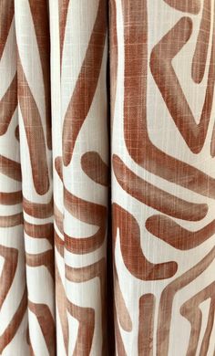 curtains with brown and white designs on them