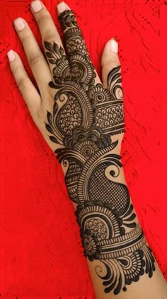 a woman's hand is decorated with hennap and intricate designs on it