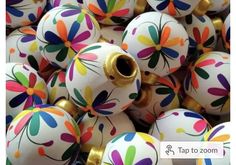 many different colored balls with flowers painted on them