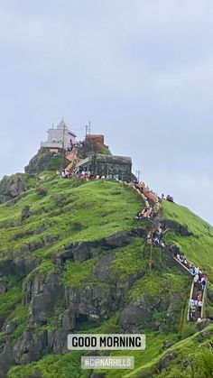 people are climbing up the side of a hill