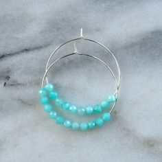 Think of these semi precious beaded hoop earrings as Libby & Smee Deluxe! Quite simply, these'll be the hoops that you'll want to wear every single day. 45mm (about 1.75") gold-filled or sterling silver hoops with faceted Amazonite gemstone beads packaged on a kraft earring card in a clear resealing bag gold-filled hoops are lead-free gold over brass. Gold-filled has much more gold than gold-plated and will last longer without tarnishing. Not sure which gemstone to choose? This blog post mig Faceted Hoop Earrings As Gift, Hoop Earrings With Spacer Beads As Gift, Hoop Earrings With Spacer Beads For Gifts, Hoop Jewelry With Faceted Beads For Gifts, Round Hoop Earrings With Spacer Beads For Gift, Small Hoop Earrings With Faceted Beads For Gift, Small Hoop Jewelry With Faceted Beads For Gifts, Earring Card, Gold Filled Hoops