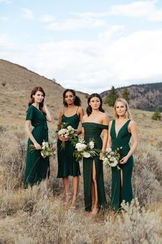 the bridesmaids are wearing green dresses and holding bouquets in their hands while posing for a photo