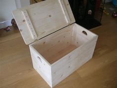 a wooden box sitting on top of a hard wood floor