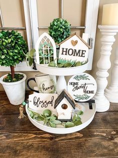 three tiered trays with birdhouses and plants