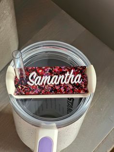 a blender with some liquid in it on top of a wooden table next to a sign that says samantaha