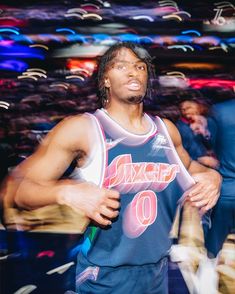 a man in a basketball uniform is looking up at the sky