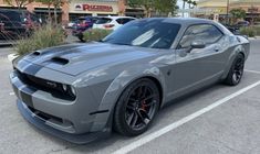 a gray sports car parked in a parking lot