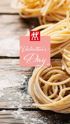 some pasta on a wooden table with the words valentine's day