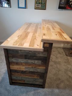 an office desk made out of pallet wood in the middle of a carpeted room