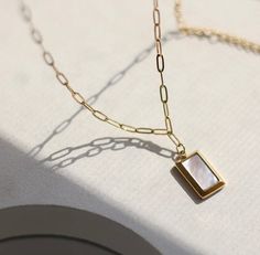 Sidney Square Mother of Pearl Pendant Necklace Necklaces TRENDZIO Elegant Stainless Steel Necklace With Rectangular Pendant, Dainty Gold Mother Of Pearl Necklace, Elegant Stainless Steel Square Pendant Necklace, Chic Gold Mother Of Pearl Jewelry, Chic Mother Of Pearl Jewelry For Gift, Chic Mother Of Pearl Jewelry For Gifts, Minimalist Gold Jewelry With Mother Of Pearl, Polished Mother Of Pearl Necklace For Gift, Modern Gold Jewelry With Mother Of Pearl