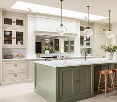 a kitchen with an island and two stools in front of the countertop area