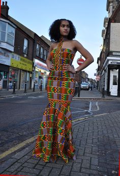 CUSTOM MADE: Our prom dresses are to be custom made in any fabric seen - tell us your size and fabric, and we will get it to you for your special day! This beautiful elegant Kente dress with fish tale front and back bottom is fully lined with back zip, which will make a statement for any special event   Body-Corn fit with flare bottom Halter neck line Back zip Sleeveless 100% Cotton Delivery will be between 2 to 3 weeks for tailor-made products! African Print Prom Dress, Flare Long Gown, Prom Dress High Neck, Prom Dress African, African Clothing Stores, High Neck Prom Dress, Kente Print, Ankara Long Gown Styles, Kente Dress