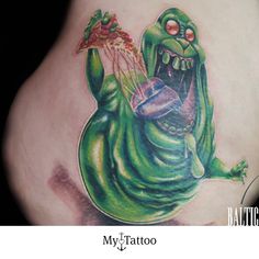 a tattoo with an image of a green creature